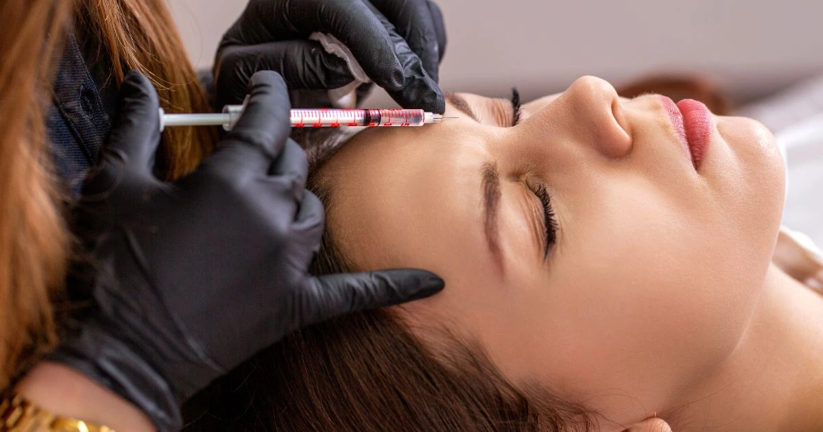 Skilled injector administering Botox for frown lines with precision, demonstrating the artistic skill required for natural results.