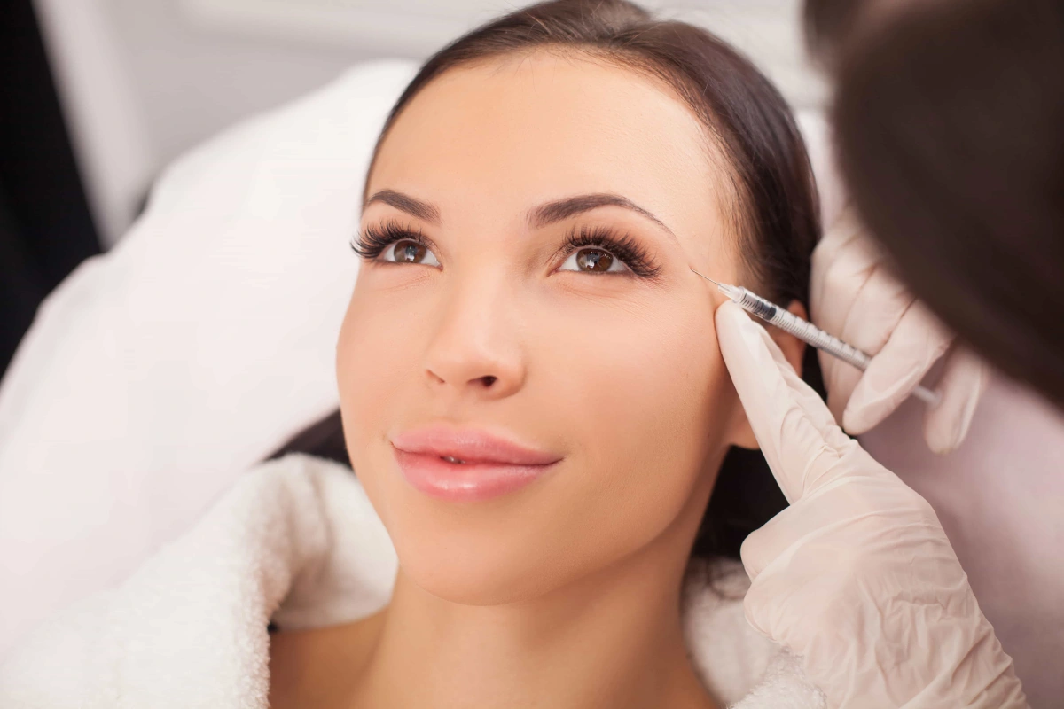 Woman receiving Botox treatment to smooth facial wrinkles and fine lines